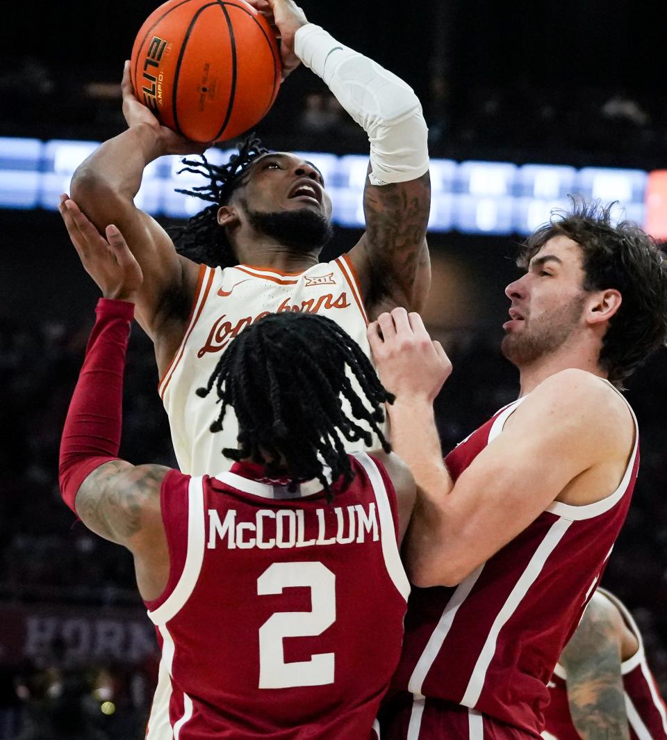 Texas guard Tyrese Hunter battles Oklahoma defenders under the basket during the Longhorns' victory in their regular-season finale Saturday at Moody Center. UT stumbled in its Big 12 Tournament opener Wednesday night and must wait till Selection Sunday to learn its NCAA Tournament fate.