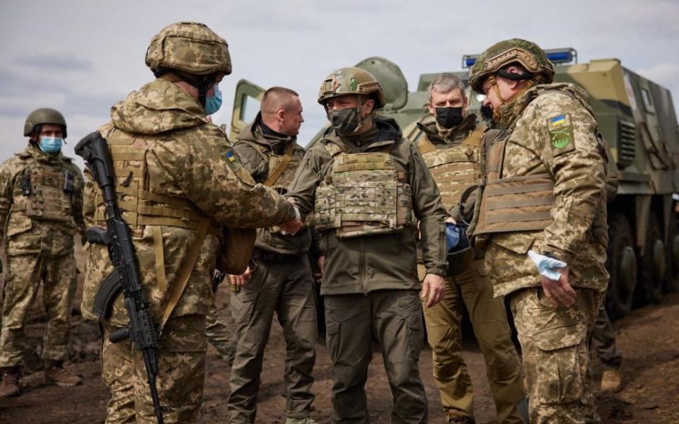 Volodymyr Zelensky (C) shaking hand to a serviceman on the frontline with Russia backed separatists near Zolote, Lugansk region - STR/UKRAINIAN PRESIDENTIAL PRESS SER/AFP via Getty Images