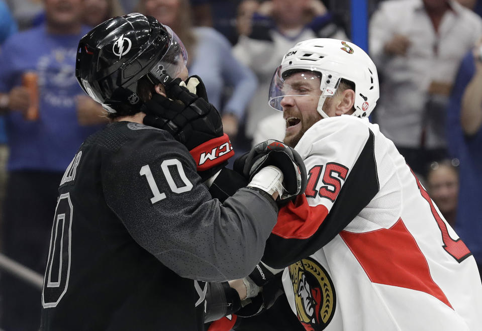 Ottawa Senators left wing Zack Smith (15) and Tampa Bay Lightning center J.T. Miller (10) battle during the second period of an NHL hockey game Saturday, March 2, 2019, in Tampa, Fla. Both players received roughing minor penalties. (AP Photo/Chris O'Meara)