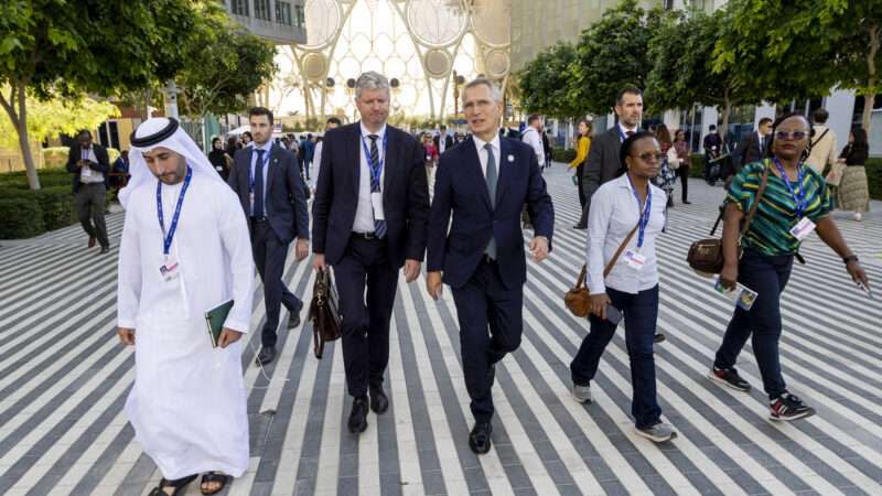 Attendees of the Cop28 climate conference in Dubai walking