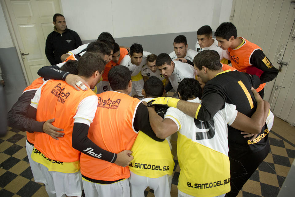 Soccer players from the team "Papa Francisco," or Pope Francis, huddle before their match against Trefules in Lujan, Argentina, Saturday, April 12, 2014. The new semiprofessional team named after the Argentine pontiff chose the colors of the Vatican flag for their uniforms. (AP Photo/Victor R. Caivano)