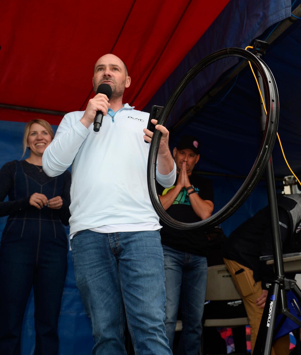 Boyd and Nicole Johnson of Boyd Cycling company make the announcement that their company is coming to Landrum at the bike races at Spring Fling in Spartanburg on April 26, 2024.