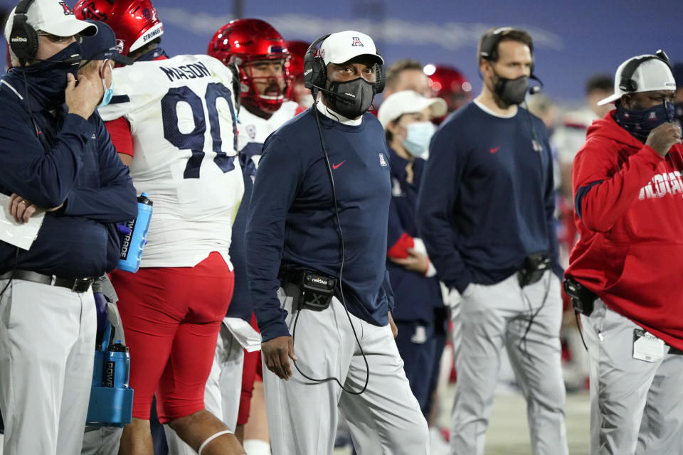 Arizona coach Kevin Sumlin, center, watches from the sideline during the first half of the team's NCAA college football game against UCLA on Saturday, Nov. 28, 2020, in Pasadena, Calif. (AP Photo/Marcio Jose Sanchez)