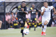 Columbus Crew's Derrick Etienne left, and Chicago Fire's Miguel Angel Navarro chase the ball during the first half of an MLS soccer match Saturday, June 19, 2021, in Columbus, Ohio. (AP Photo/Jay LaPrete)