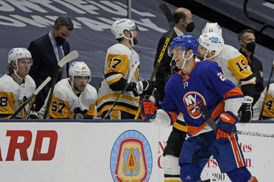 New York Islanders Oliver Wahlstrom (26) skates past the Pittsburgh Penguins bench after scoring on a power play at the end of the first period of an NHL hockey game, Sunday, Feb. 28, 2021, in Uniondale, N.Y. (AP Photo/Kathy Willens)