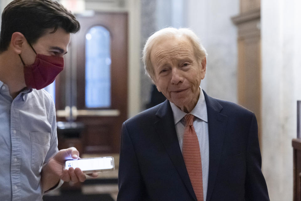 FILE - Former Sen. Joe Lieberman of Conn., right, speaks with a reporter at the Capitol in Washington, June 22, 2021. Lieberman, who nearly won the vice presidency on the Democratic ticket with Al Gore in the disputed 2000 election and who almost became Republican John McCain's running mate eight years later, has died Wednesday, March 27, 2024, according to a statement issued by his family. He was 82. (AP Photo/Alex Brandon, File)