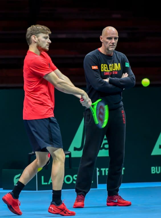 Belgium's captain Johan Van Herck (R) watches as David Goffin hits a return during a training session in Villeneuve d'Ascq on November 22, 2017, ahead of their Davis Cup World Group final against France