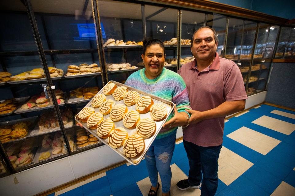 Maria and Andres Cervantes pose for a portrait with a tray of conchas Tuesday, May 2, 2022 at La Central Panaderia in South Bend. 