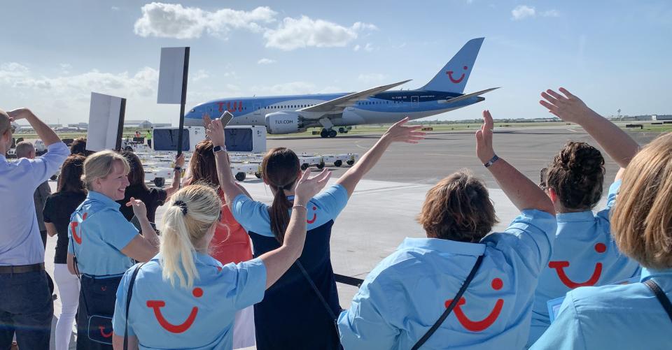 Well-wishers greet the inaugural TUI Airways jumbo jet as it rolls toward Gate 8 in March 2022 at Melbourne Orlando International Airport.