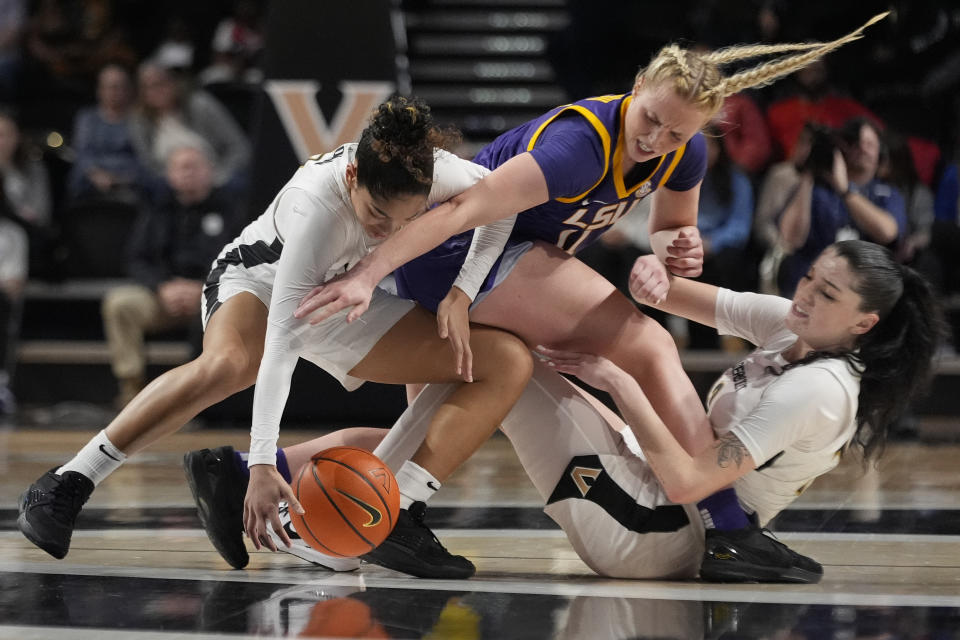 LSU guard Hailey Van Lith, center, battles Vanderbilt guard Jada Brown, left, and guard Justine Pissott, right, for the ball during the first half of an NCAA college basketball game Thursday, Feb. 8, 2024, in Nashville, Tenn. (AP Photo/George Walker IV)