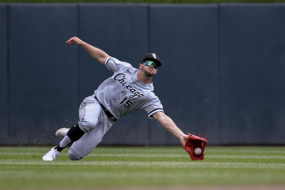 Chicago White Sox center fielder Adam Engel catches a fly ball hit by Minnesota Twins' Carlos Correa during the first inning of a baseball game, Sunday, July 17, 2022, in Minneapolis. The Twins won 6-3. (AP Photo/Craig Lassig)