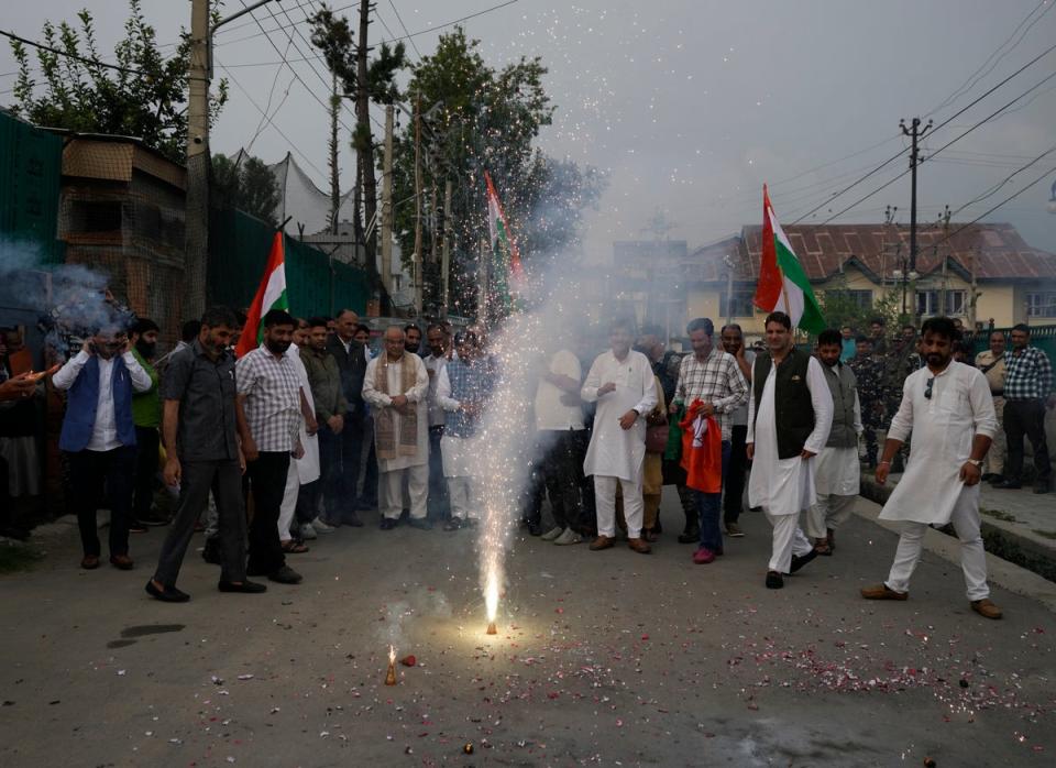 Bharatiya Janata Party (BJP) workers light firecrackers in Srinagar, Indian controlled Kashmir (AP)