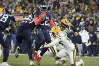 Tennessee Titans running back Derrick Henry (22) runs the ball as Green Bay Packers linebacker Kingsley Enagbare (55) and others attempt to make the stop during the second half of an NFL football game Thursday, Nov. 17, 2022, in Green Bay, Wis. (AP Photo/Morry Gash)