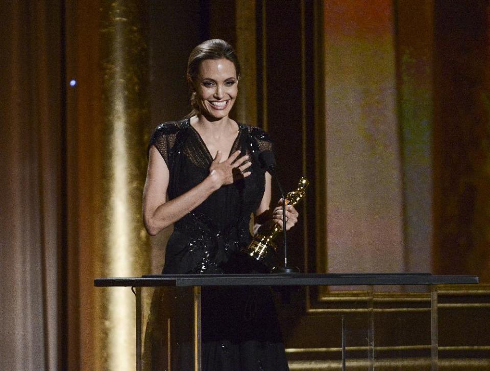 FILE - In this Nov. 16, 2013 file photo, actress and honoree Angelina Jolie receives the Jean Hersholt Humanitarian Award at the 2013 Governors Awards in Los Angeles. The 38-year-old Oscar winner came to the Dolby Theater in Los Angeles on Thursday, Feb. 27, 2014, to run through the lines she’ll say in front of millions at the 86th Academy Awards on Sunday, March 2, 2014. Afterward, she hung around chatting to show producers and introduced herself as “Angie” to a group of college students serving as trophy carriers this year. (Photo by Dan Steinberg/Invision/AP, file)