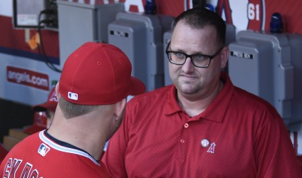 Mike Trout of the Los Angeles Angels speaks to Eric Kay in the dugout