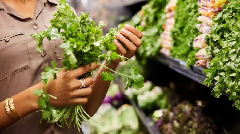 Woman inspecting herbs