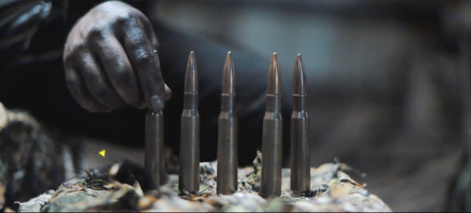 In this image from a propaganda video released by Hamas in October 2023, a fighter lines up cartridges for a large sniper rifle. Weapons experts told The Associated Press the gun is an Iranian-made AM-50 Sayyad, which fires a .50- caliber round powerful enough to punch through up to an inch of steel. The AM-50 has previously been spotted on battlefields in Yemen, Syria, and in the hands of Shia militias in Iraq. (Hamas via AP)