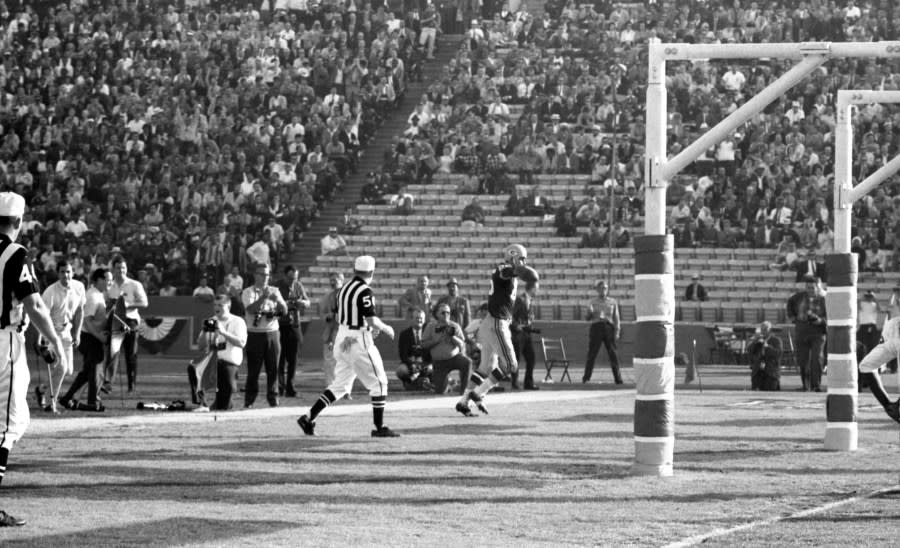 LOS ANGELES, CA – JANUARY 15, 1967: Wide receiver Max McGee #85 of the Green Bay Packers tosses the ball to the official after catching a 13-yard touchdown pass from quarterback Bart Starr in the third quarter of Super Bowl I on January 15, 1967 against the Kansas City Chiefs at the Los Angeles Memorial Coliseum in Los Angeles, California. The Packers beat the Chiefs, 35-10 to win the professional football World Championship. 19670115-FR-179 1967 Kidwiler Collection/Diamond Images