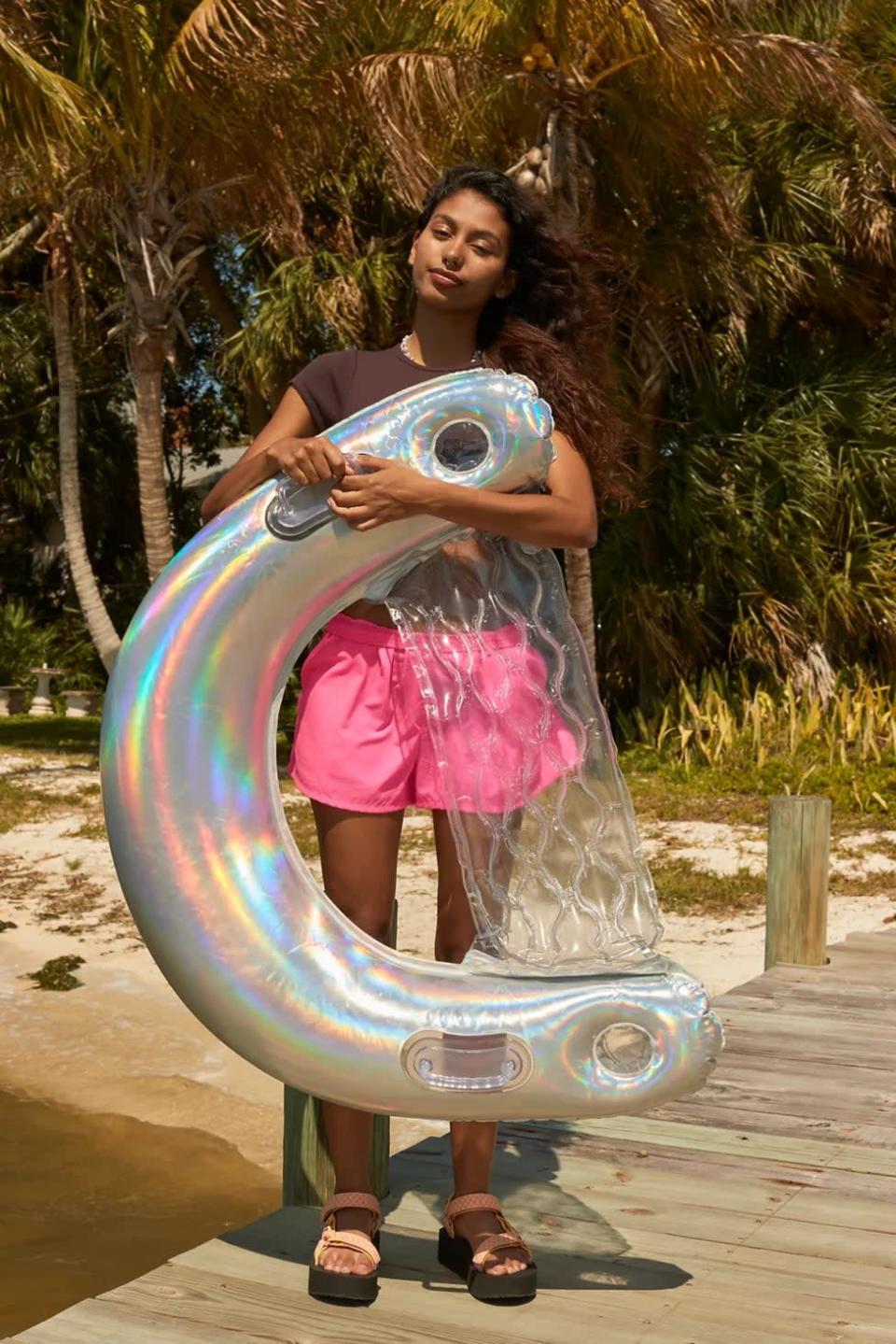<p>If you're living for all things glittery, the <span>Glitter Chair Pool Float</span> ($25) is something you need in your collection. It's equipped with a supportive backrest, two cup holders, and two handles for comfort floating. It comes in an iridescent silver shade, a glittery pink shade, and a glittery orange-yellow shade. </p>