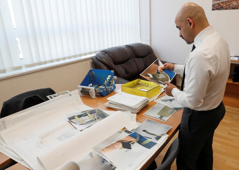 Deputy Director General of Ukroboronprom Nayyem shows instructions and designs of an old ventilator in Kiev