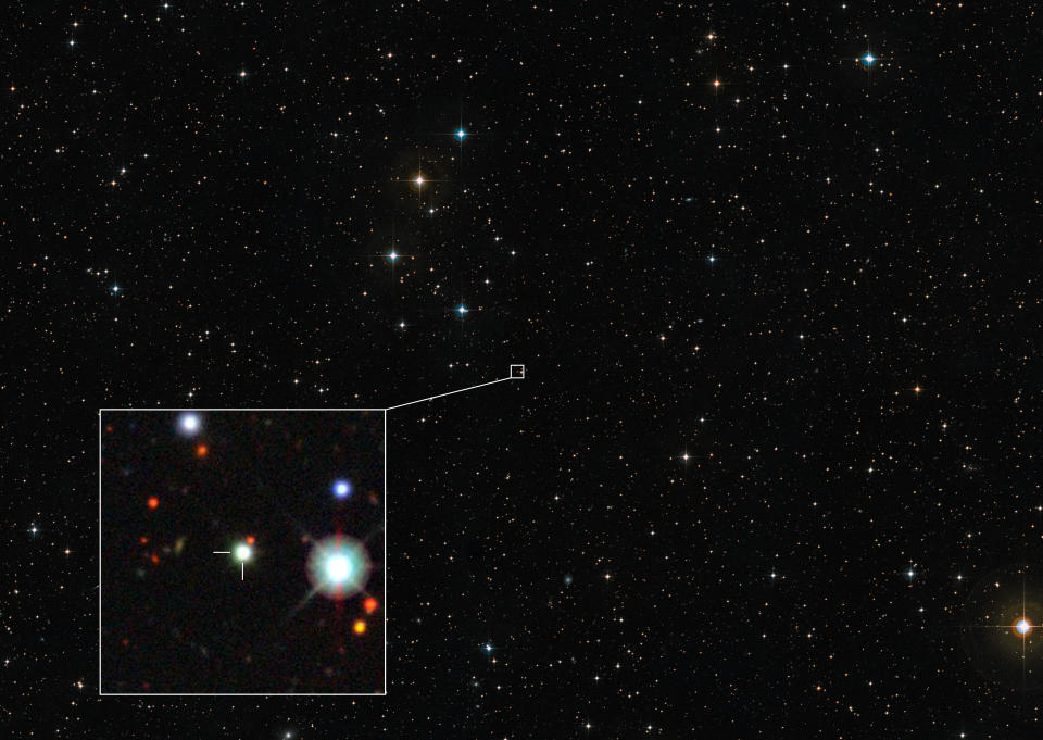 A view of stars in the night sky with a box highlighting the area around the quasar in question.