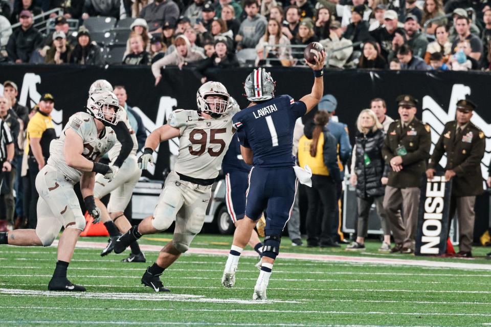 Army's Nolan Cockrill (95) gets a pass rush on Navy quarterback Tai Lavatai (1) in December. VINCENT CARCHIETTA/USA TODAY Sports