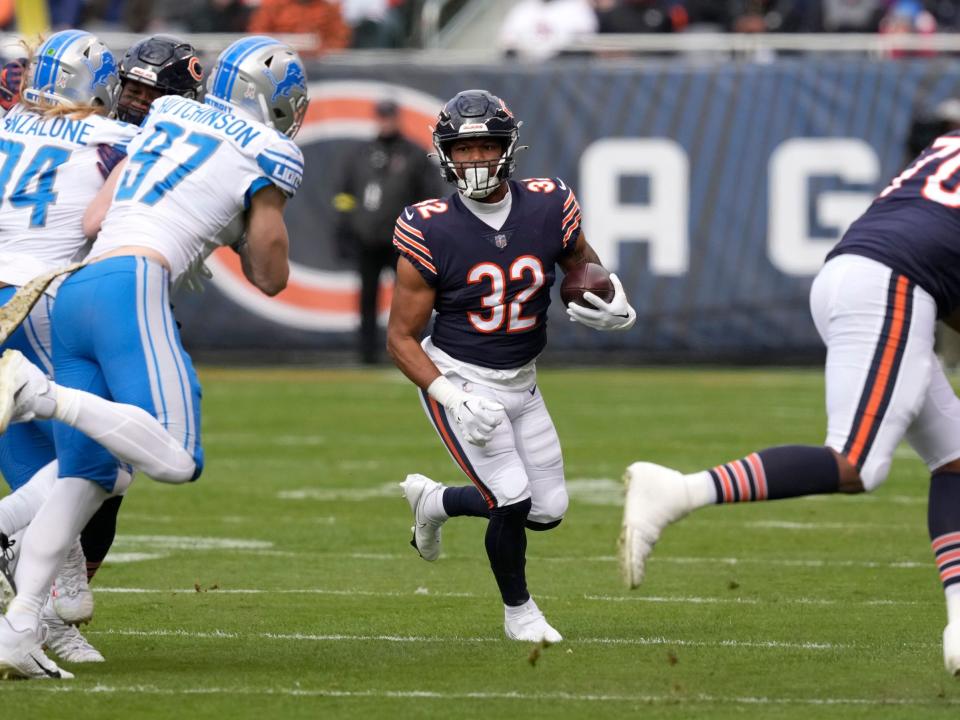 David Montgomery runs with the ball against the Detroit Lions.