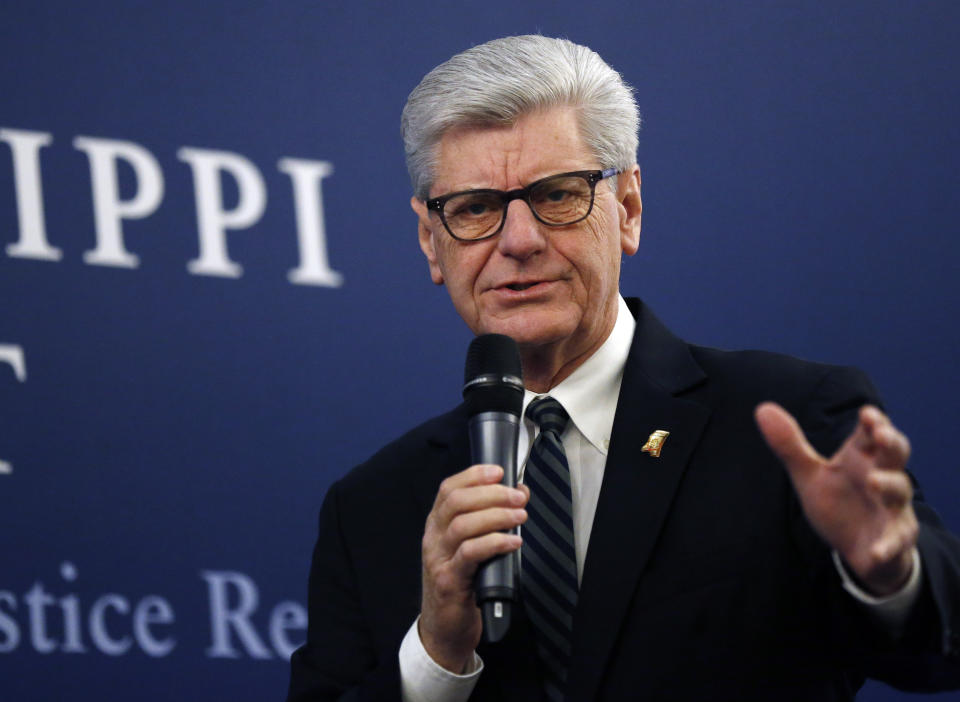 Gov. Phil Bryant says he'll support efforts to reduce the number of Mississippians in prison in the 2019 legislative session during a discussion on criminal justice reform, at the Mississippi Summit on Criminal Justice Reform in Jackson, Miss., Tuesday, Dec. 11, 2018. The meeting was put on by a coalition of groups that favor changes to reduce harshness in the criminal justice system. (AP Photo/Rogelio V. Solis)