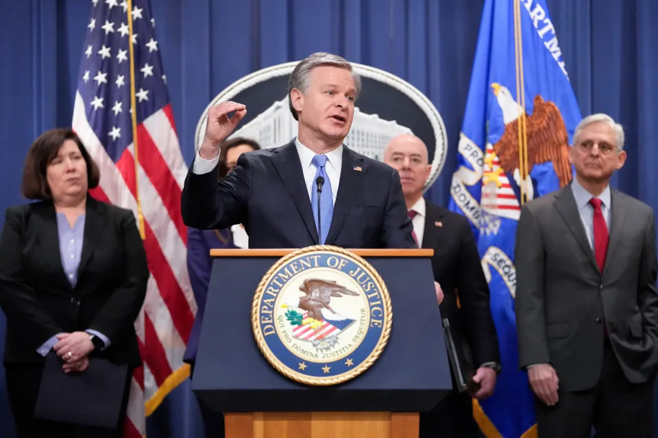 FBI Director Christopher Wray, speaks with reporters during a news conference at the Department of Justice on Dec. 6, 2023, in Washington, as from left, Senior Official Performing the Duties of the Deputy Director Staci Barrera, of U.S. Immigration and Customs Enforcement, Assistant Attorney General Nicole M. Argentieri of the Criminal Division, Secretary of Homeland Security Alejandro Mayorkas and Attorney General Merrick Garland, look on.