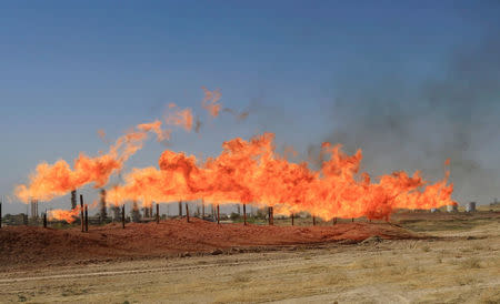 FILE PHOTO: Flames emerge from flare stacks at the oil fields in Kirkuk, Iraq October 18, 2017. REUTERS/Alaa Al-Marjani /File Photo