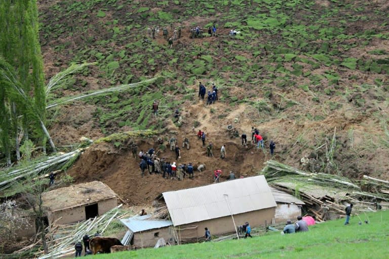 A handout picture taken on April 29, 2017 and provided by the Kyrgyz Red Crescent Society press service shows rescue workers and soldiers working at the site of a landslide in the village of Ayu in Kyrgyzstan's Osh region