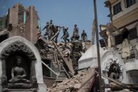 Nepalese soldiers clear rubble of a building at the damaged Swayambhunath temple in Kathmandu, on May 2, 2015