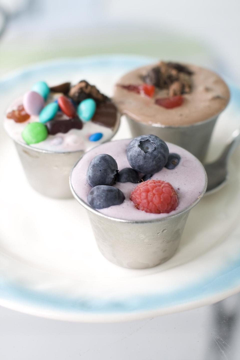 This July 22, 2013 photo shows, from left clockwise, Concession Stand, Dark Horse Cherry and Berry Basket DIY ice cream flurries in Concord, N.H. (AP Photo/Matthew Mead)