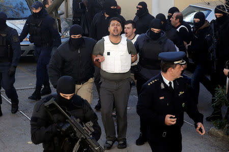 Eight men and a woman holding Turkish citizenship, who were arrested on suspected links to a leftist militant group outlawed in Turkey following an operation by Greek security services, are escorted by anti-terrorism police officers to the prosecutor's office in Athens, Greece, November 29, 2017. REUTERS/Alkis Konstantinidis