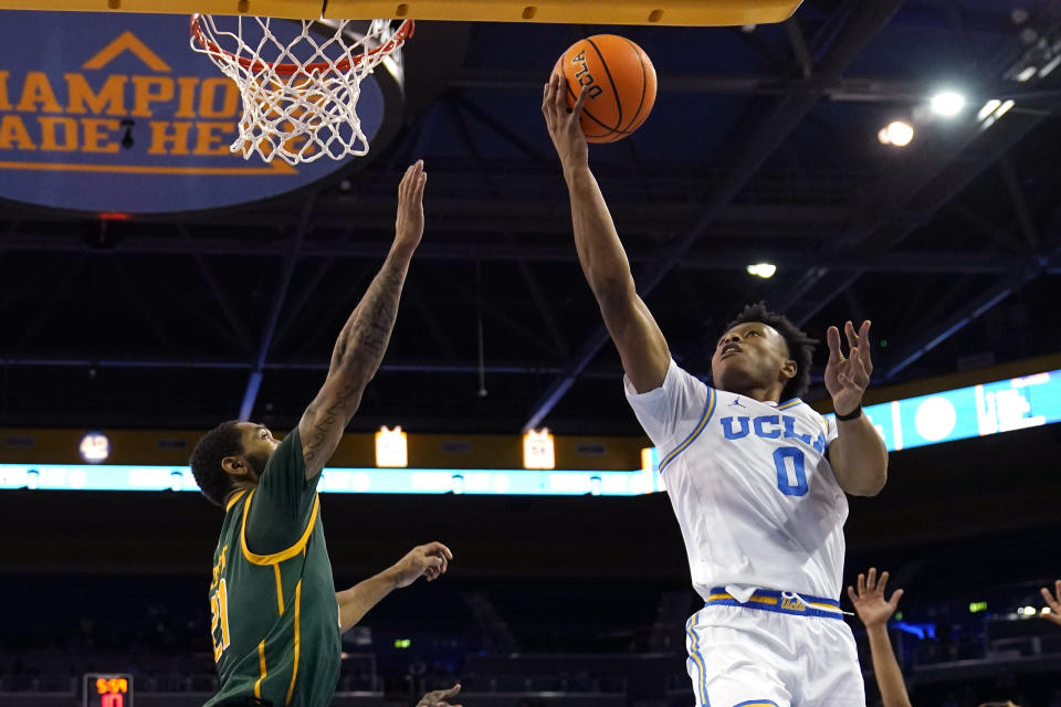 UCLA guard Jaylen Clark, right, shoots as Norfolk State forward Dana Tate Jr. defends during the first half of an NCAA college basketball game Monday, Nov. 14, 2022, in Los Angeles. (AP Photo/Mark J. Terrill)