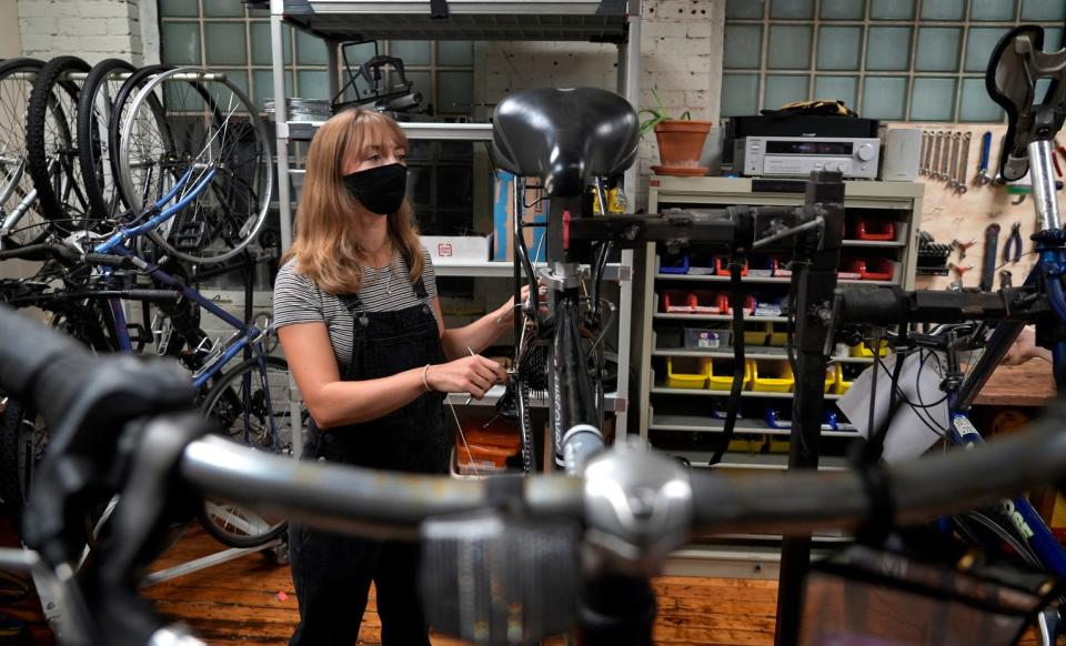 Sarah Paniati listens to instructions as she learns about bicycle maintenance at the Providence Bike Collective.
