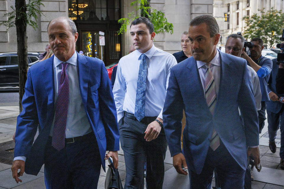 FILE - Philadelphia police Officer Mark Dial, center, arrives at the Juanita Kidd Stout Center for Criminal Justice in Philadelphia, Sept. 19, 2023, with attorneys for a bail hearing. Brian McMonagle is at left and at right is Fortunato Perri. Lawyers for Dial, who shot and killed a driver, will press to have the murder charges lodged against him dismissed when the jailed officer appears in court, Tuesday, Sept. 26. (Alejandro A. Alvarez/The Philadelphia Inquirer via AP, File)