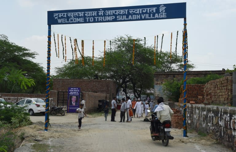 Residents pass through the gate of an Indian village unofficially renamed 'Trump Village' in an unusual gesture to the US president