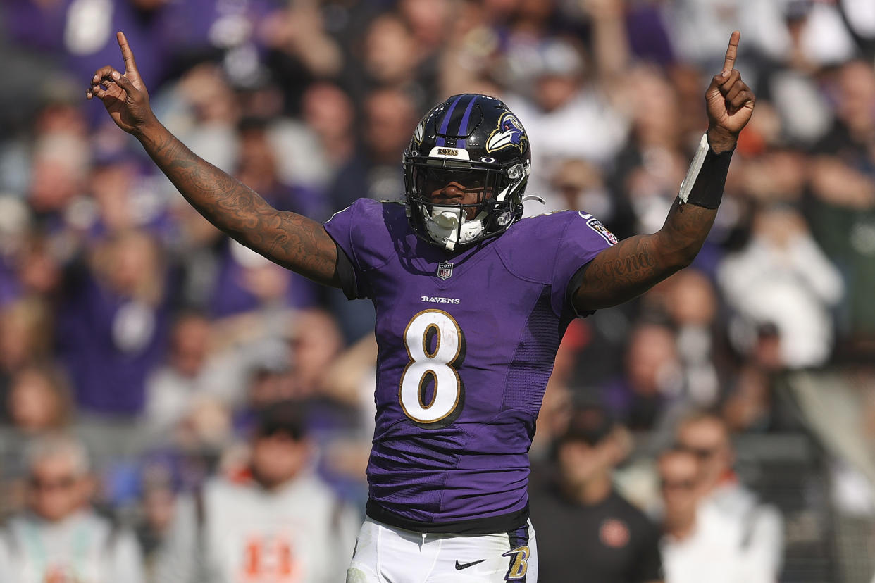 BALTIMORE, MARYLAND - OCTOBER 24: Lamar Jackson #8 of the Baltimore Ravens celebrates a rushing touchdown by Devonta Freeman #33 during the first half in the game against the Cincinnati Bengals at M&T Bank Stadium on October 24, 2021 in Baltimore, Maryland. (Photo by Patrick Smith/Getty Images)