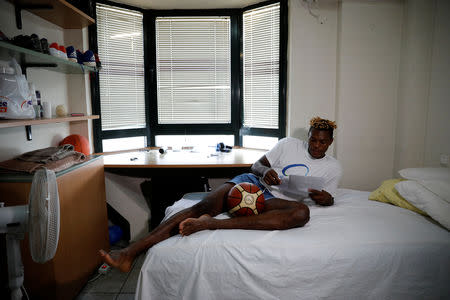 Congolese basketball player Christ Wamba studies plays of Aris Thessaloniki BC inside his room in an apartment building, provided under the UNHCR's ESTIA housing programme in Thessaloniki, Greece, September 13, 2018. REUTERS/Alkis Konstantinidis