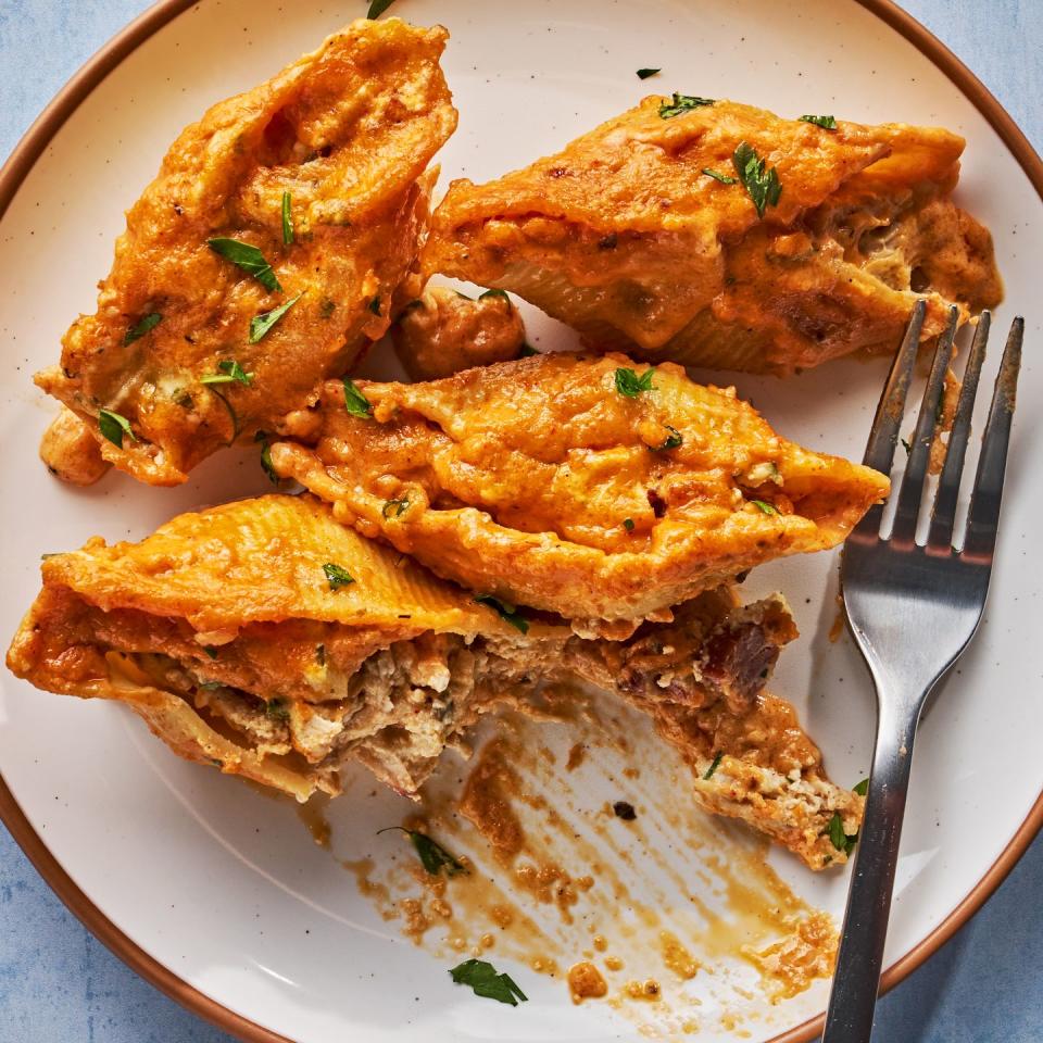 creamy cajun stuffed shells in a white baking dish