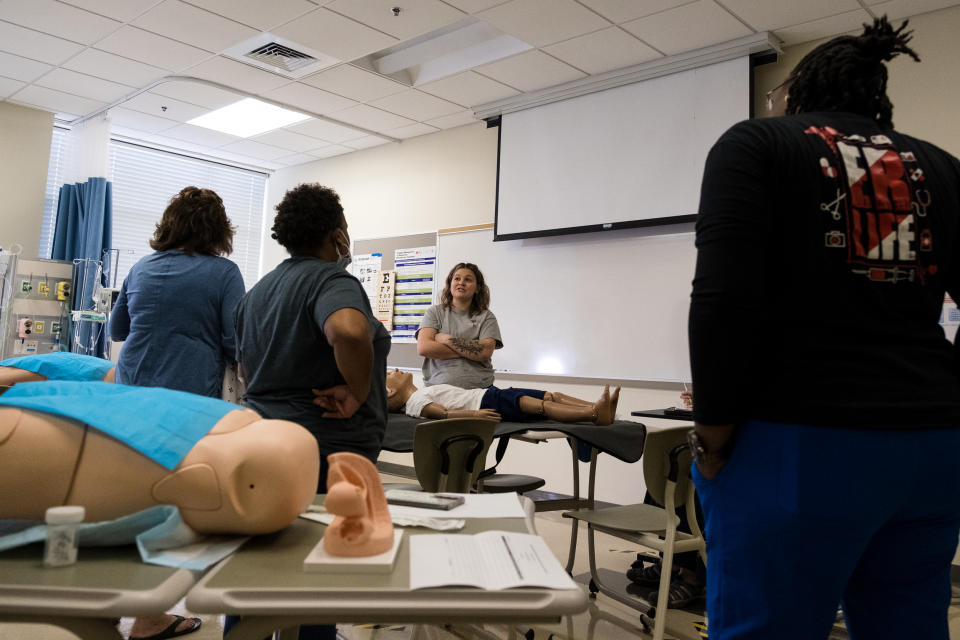 Students in the Sexual Assault Nurse Examiner training at Fayetteville State University gather practice examinations on a model (Cornell Watson for NBC News)