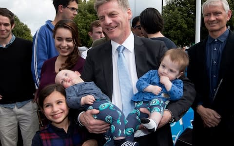 New Zealand Prime Minister Bill English holds his great-nephews, Archibald and Huxbury Scanlon, while campaigning in Hamilton, New Zealand, Friday, September 22, 2017 - Credit:   Mark Mitchell/ New Zealand Herald via AP