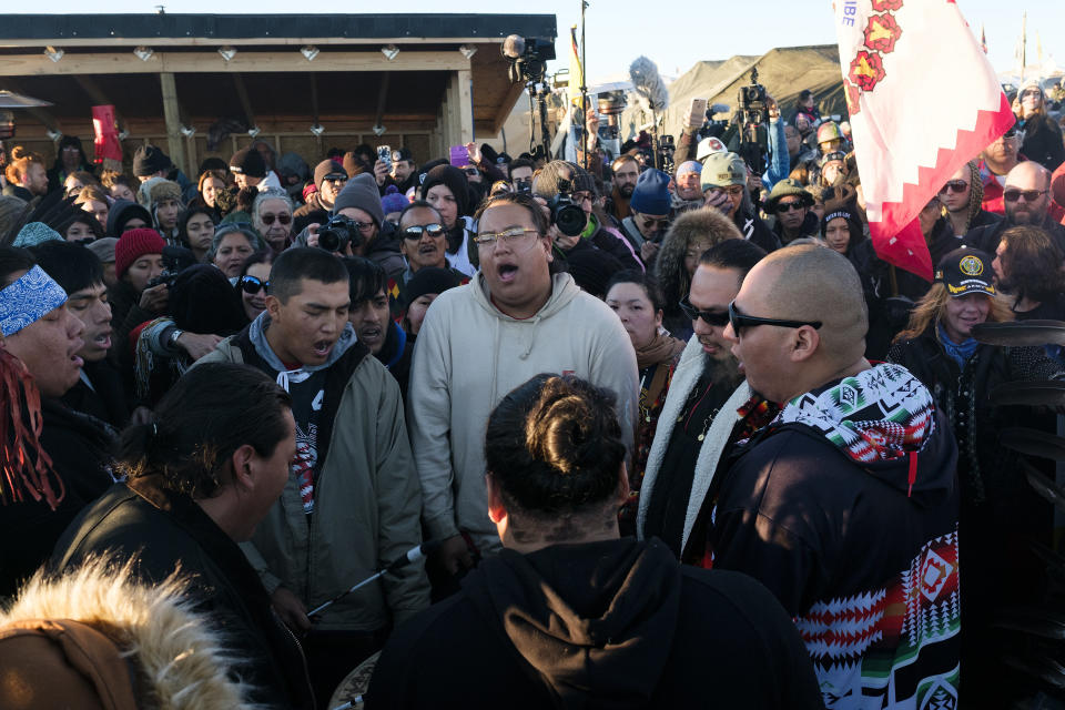 Dakota Access Pipeline protesters sing and celebrate after the Army Corps of Engineers announced they won't be granting the easement to drill under Lake Oahe.