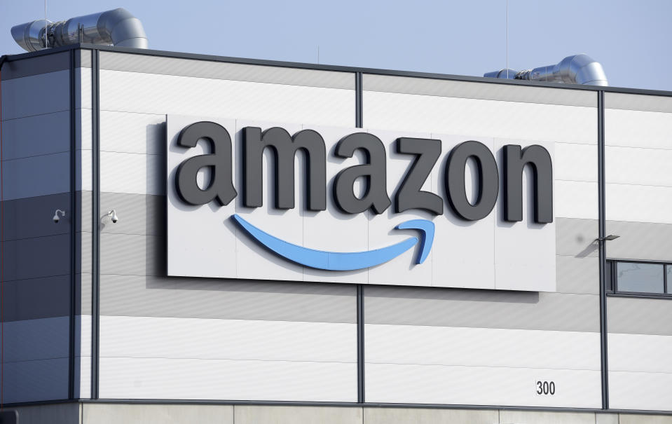FILE - An Amazon company logo marks the facade of a building in Schoenefeld near Berlin, March 18, 2022. Amazon will partner with the Diamond Sports as part of a restructuring agreement as the largest owner of regional sports networks looks to emerge from bankruptcy. Diamond owns 18 networks under the Bally Sports banner. Those networks have the rights to 37 professional teams — 11 baseball, 15 NBA and 11 NHL. (AP Photo/Michael Sohn, File)