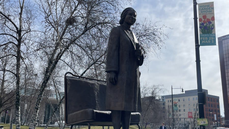 A bronze statue of Rosa Parks outside of Rosa Parks Circle in downtown Grand Rapids.