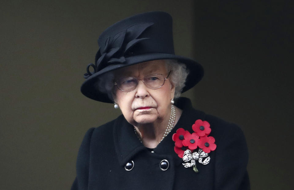 Britain's Queen Elizabeth II looks on from the balcony of the Foreign Office, during the Remembrance Sunday service at the Cenotaph, in Whitehall, London, Sunday Nov. 8, 2020. (Chris Jackson/Pool Photo via AP)