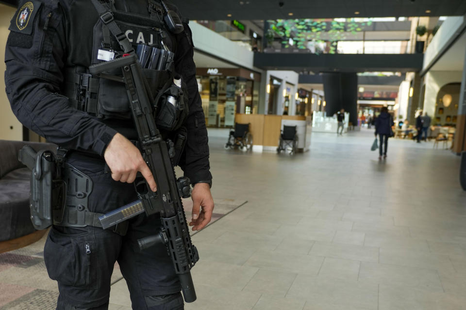 A Serbian special police officer patrols at a shopping mall in Belgrade, Serbia, Monday, March 25, 2024. Serbian government increased its security alert posture after the deadly attack at a Russian concert hall. (AP Photo/Darko Vojinovic)