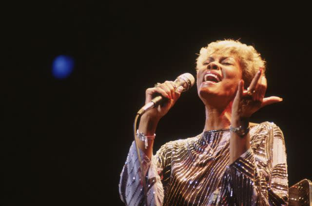 <p>Hulton Archive/Getty</p> Dionne Warwick singing in London, England