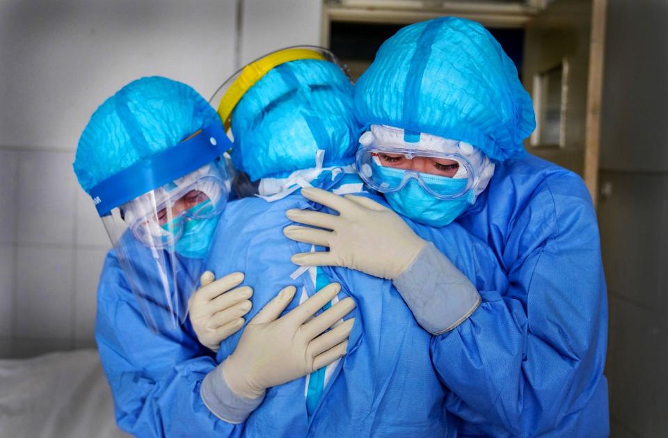 CHINA: Medical staff members hug one another in an isolation ward at a hospital in Zouping in Shandong province on Jan. 28.